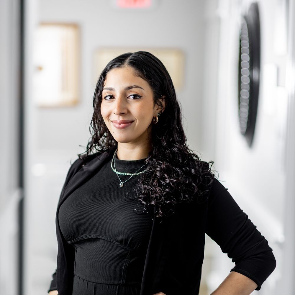 Woman smiling in a professionally styled environment.