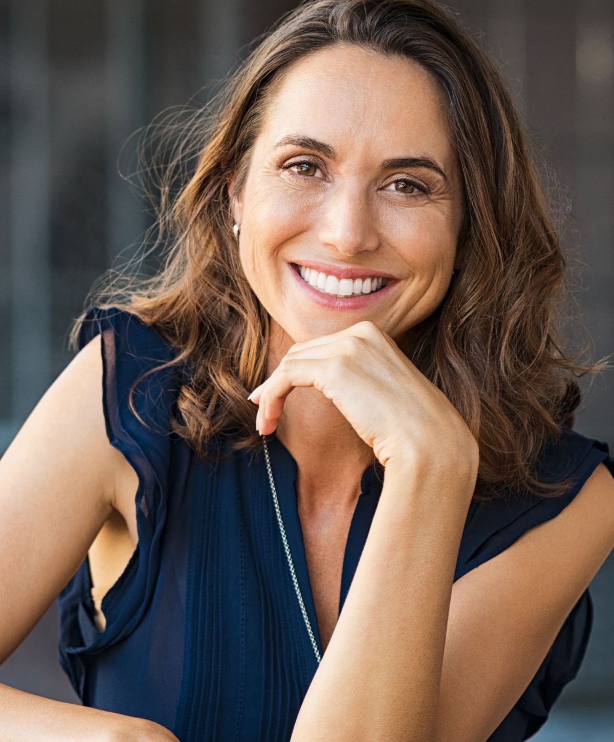 Smiling woman with long brown hair.