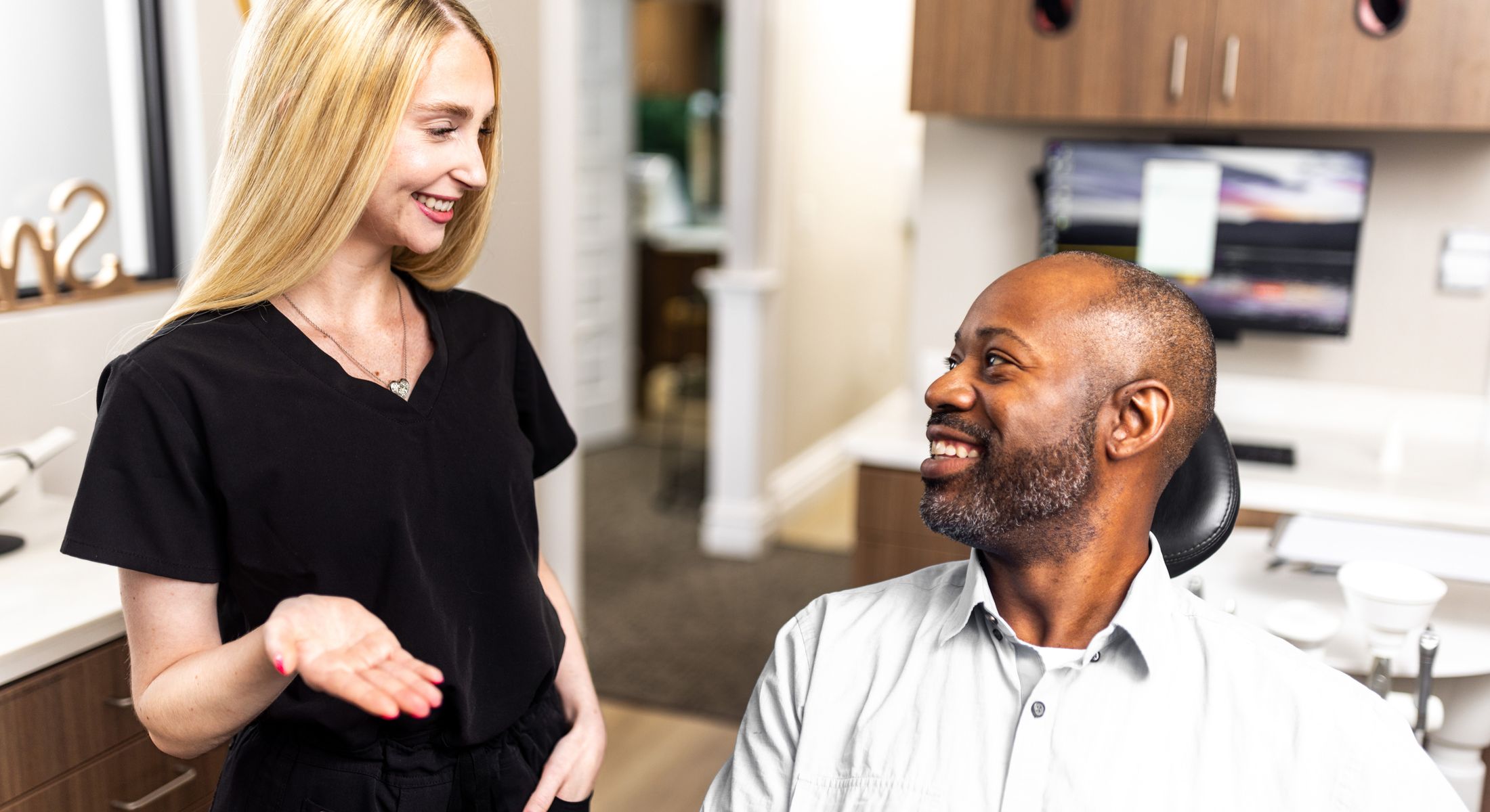 patient and staff smiling in office