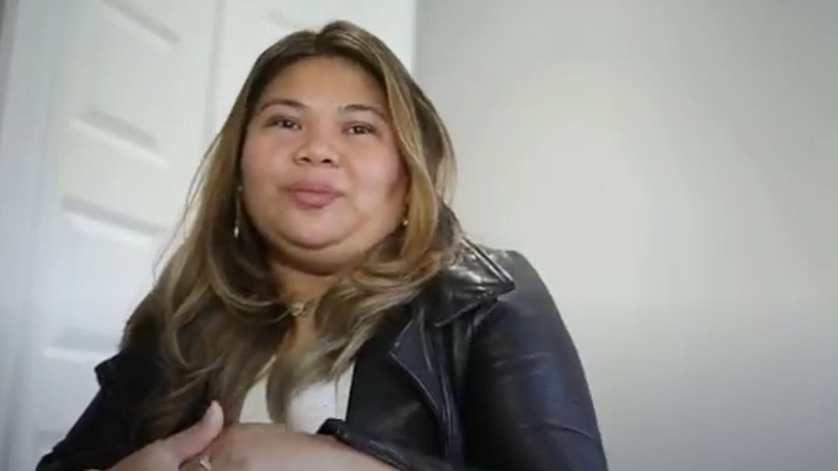 Smiling woman sitting in an office environment.